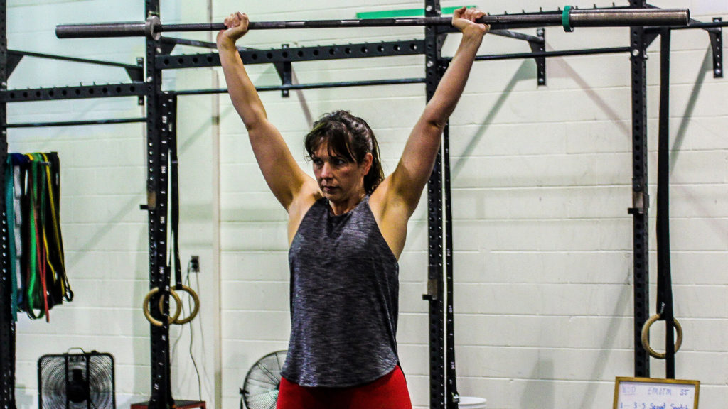 woman lifting a barbell overhead